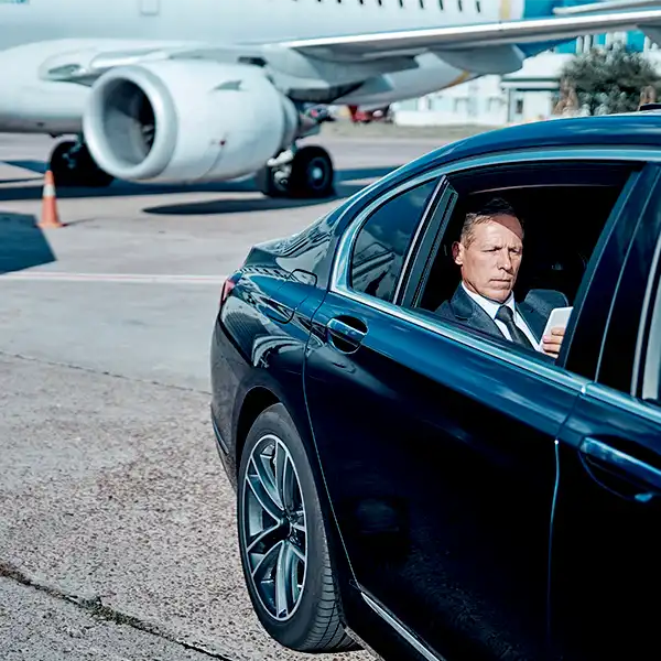 Man sitting in airport transfer sedan