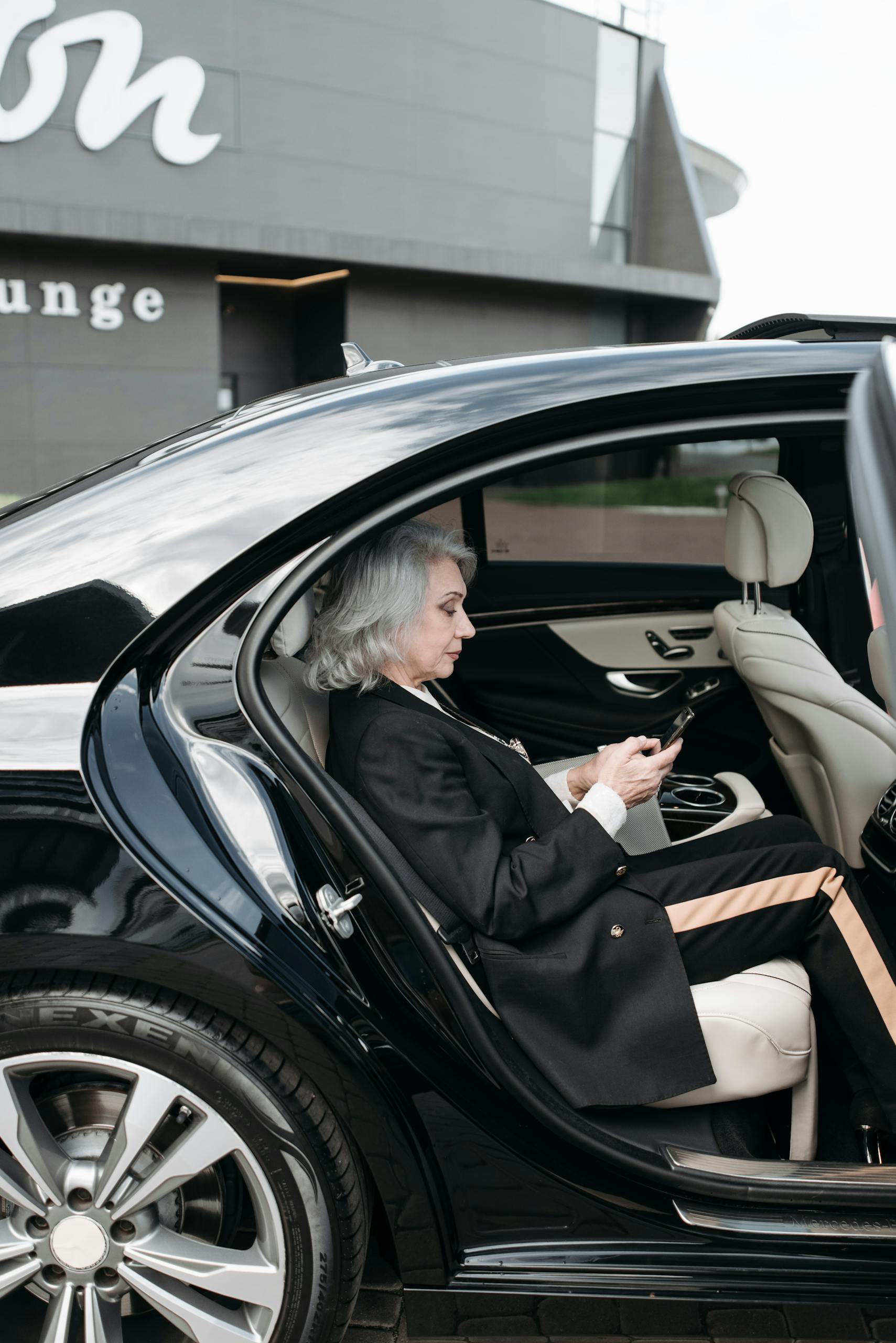 Woman in black sedan